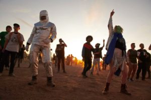 Attendees dance to music during Alienstock festival on the "Extraterrestrial Highway in Rachel, Nevada on September 20, 2019