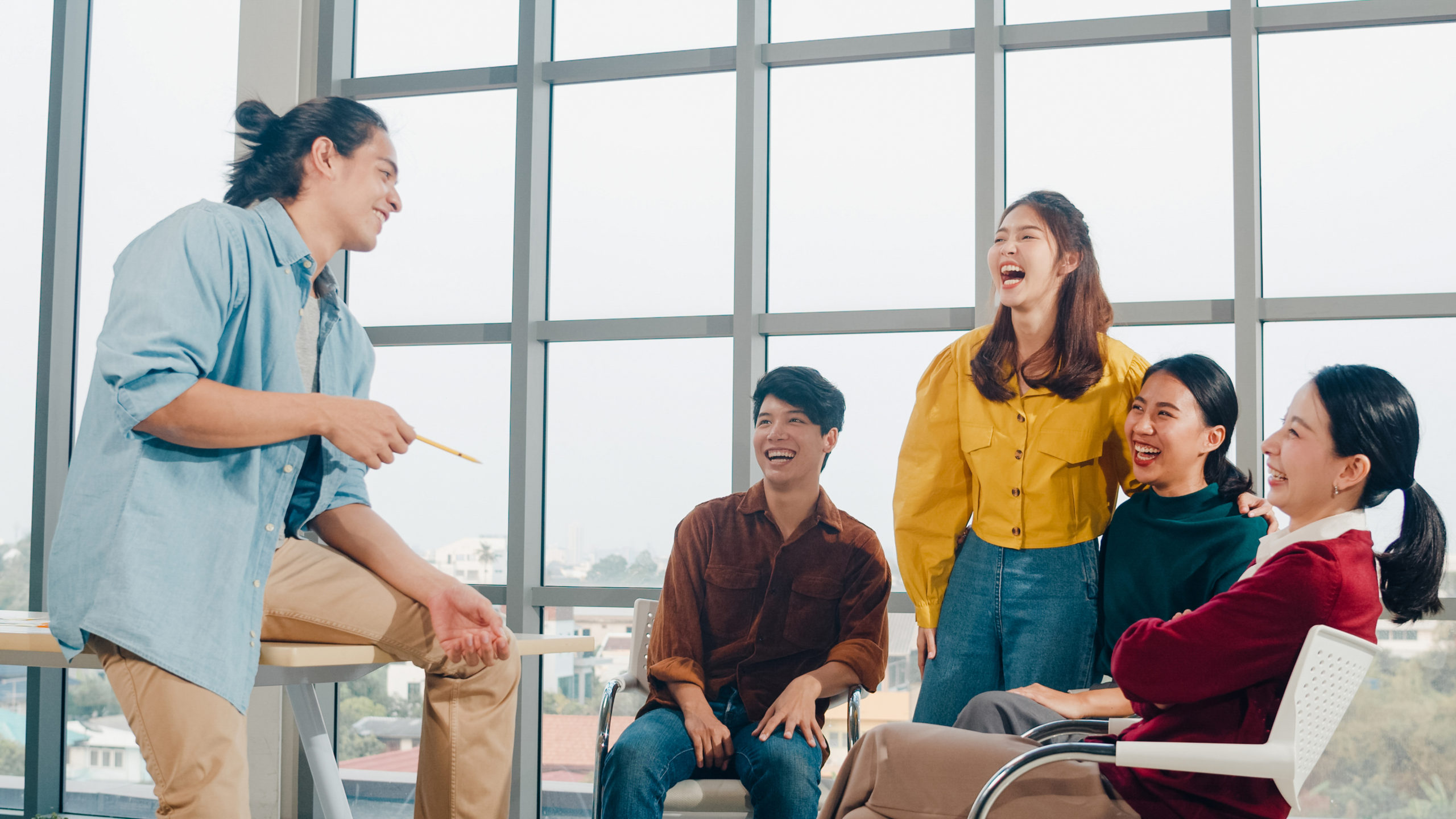 Group of young college students in smart casual wear on campus.