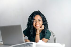 Girl looking up from laptop as she utilizes continuous learning after college